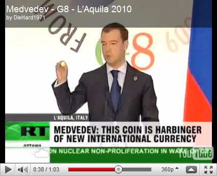 Medvedev at G8 showing a "Future World Currency" coin